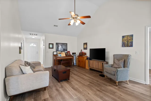 a living room with furniture and a flat screen tv