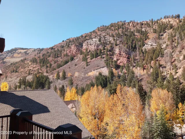 a view of a large building with mountains in the background