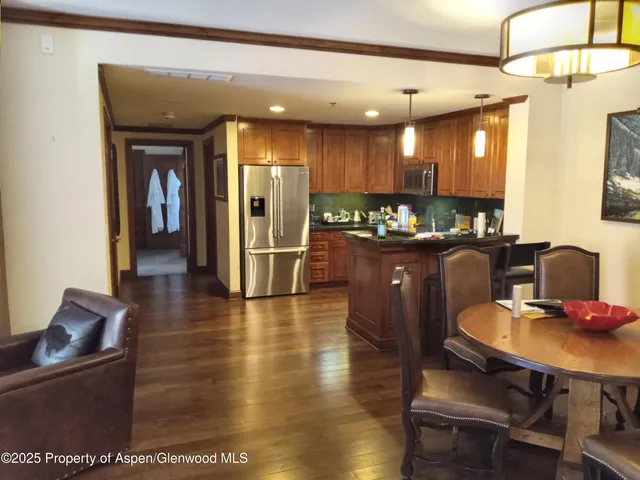 a hallway with dining table and chairs