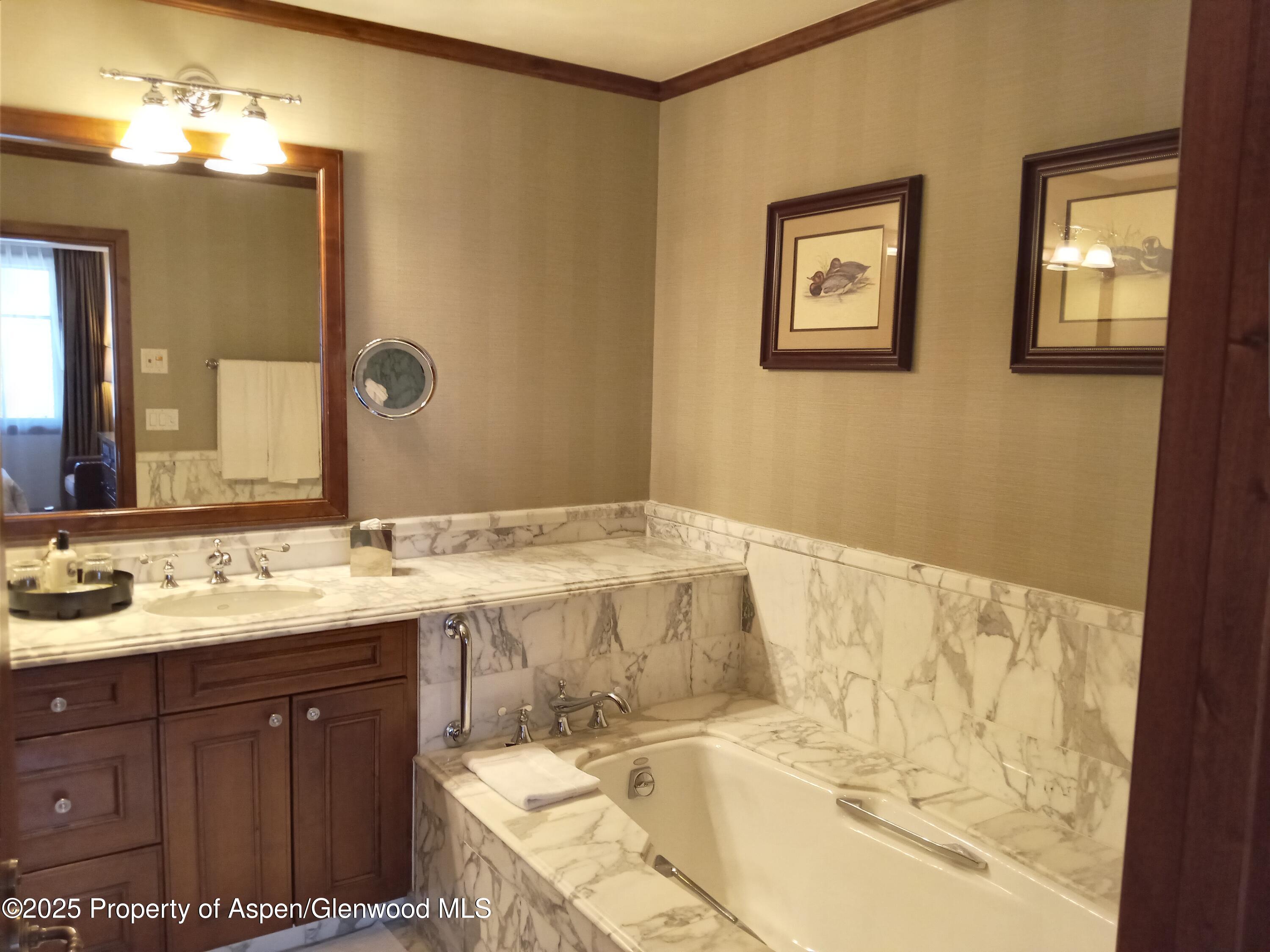 39 Boomerang Road, Unit 8411 21 Aspen, CO 81611 - Photo 25 of 25 a bathroom with a tub sink and mirror