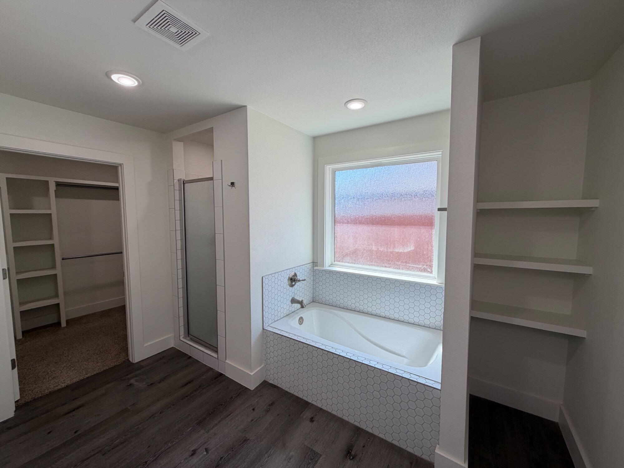 405 Ranger Street Wolfforth, TX 79382 - Photo 13 of 19 a bathroom with a bathtub and a shower