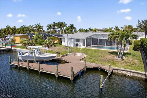 a view of a house with pool and chairs