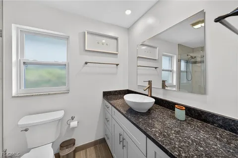 a bathroom with a toilet and a shower