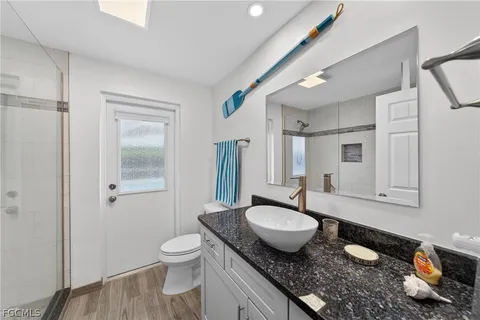 a bathroom with a glass shower door