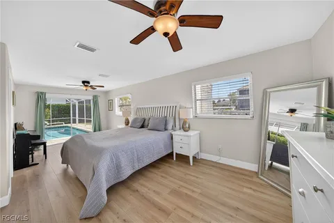 a bedroom with a bed and flat screen tv
