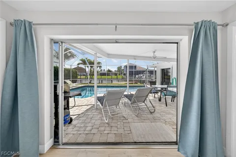 a view of a patio with a dining table and chairs