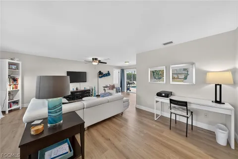 a living room with furniture and flat screen tv