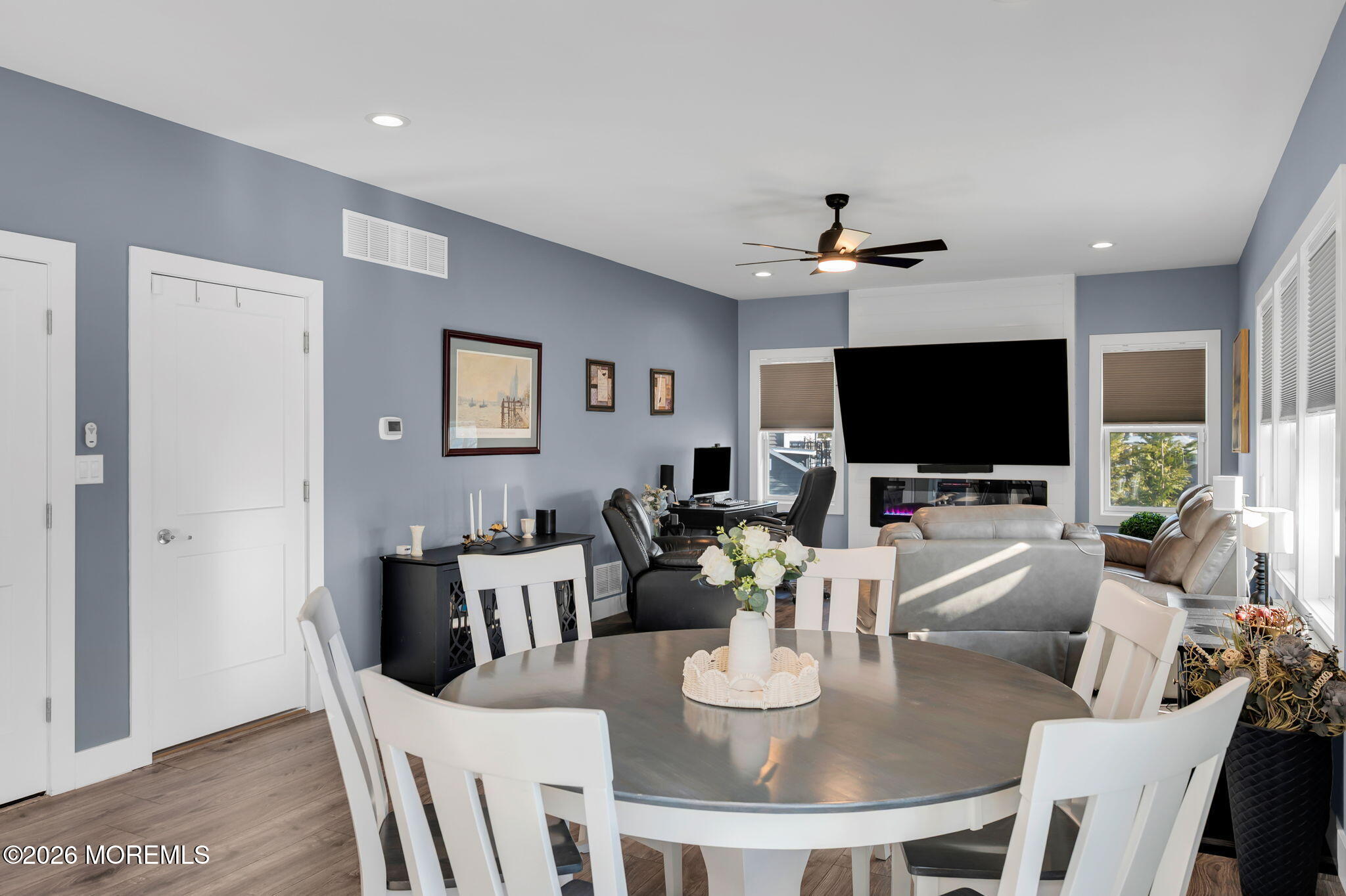 312 Elm Court Brick, NJ 08723 - Photo 17 of 57 a living room with furniture a flat screen tv and a chandelier