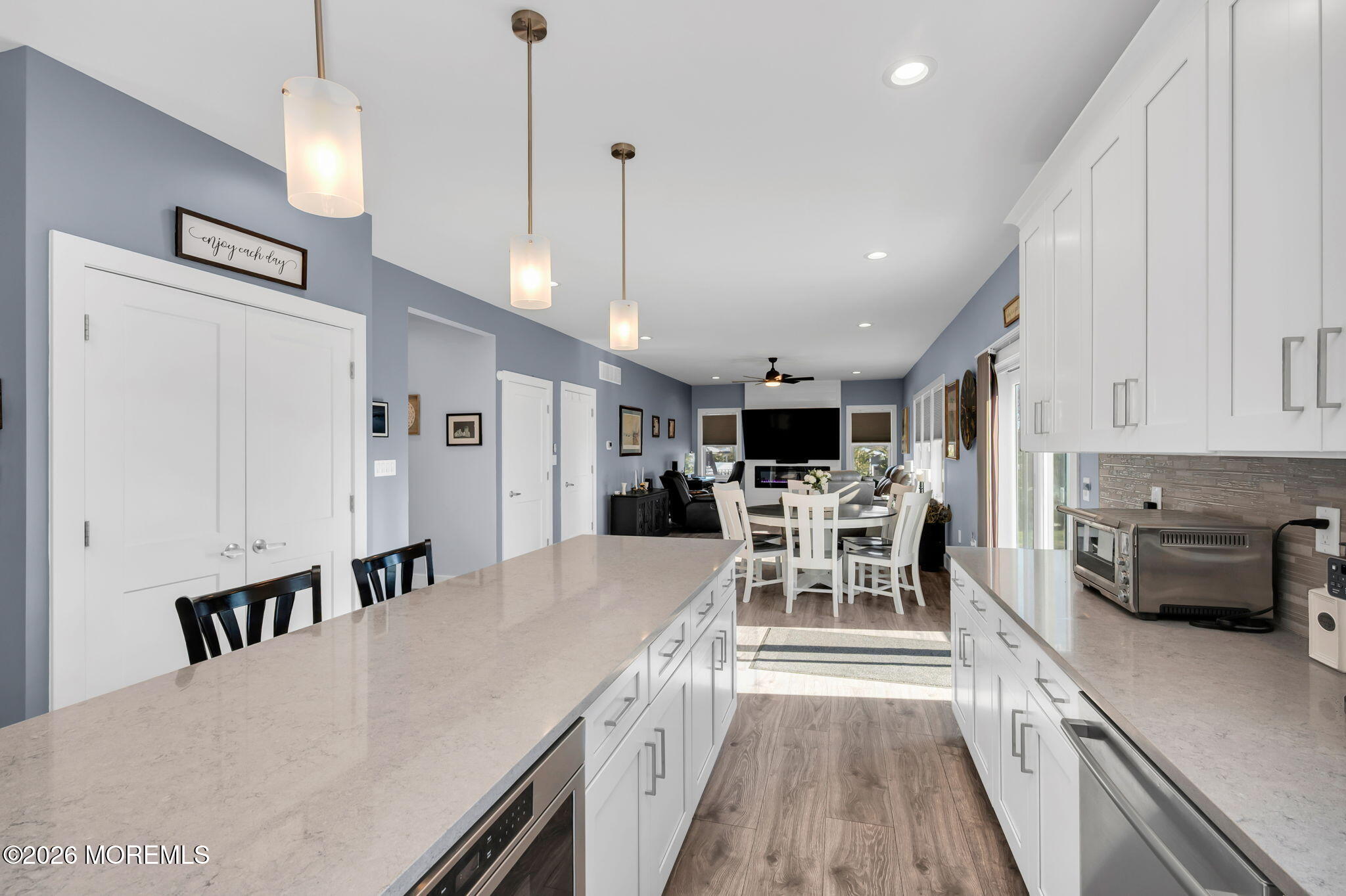 312 Elm Court Brick, NJ 08723 - Photo 24 of 57 a kitchen with stainless steel appliances kitchen island granite countertop a stove a sink a dining table and chairs with wooden floor