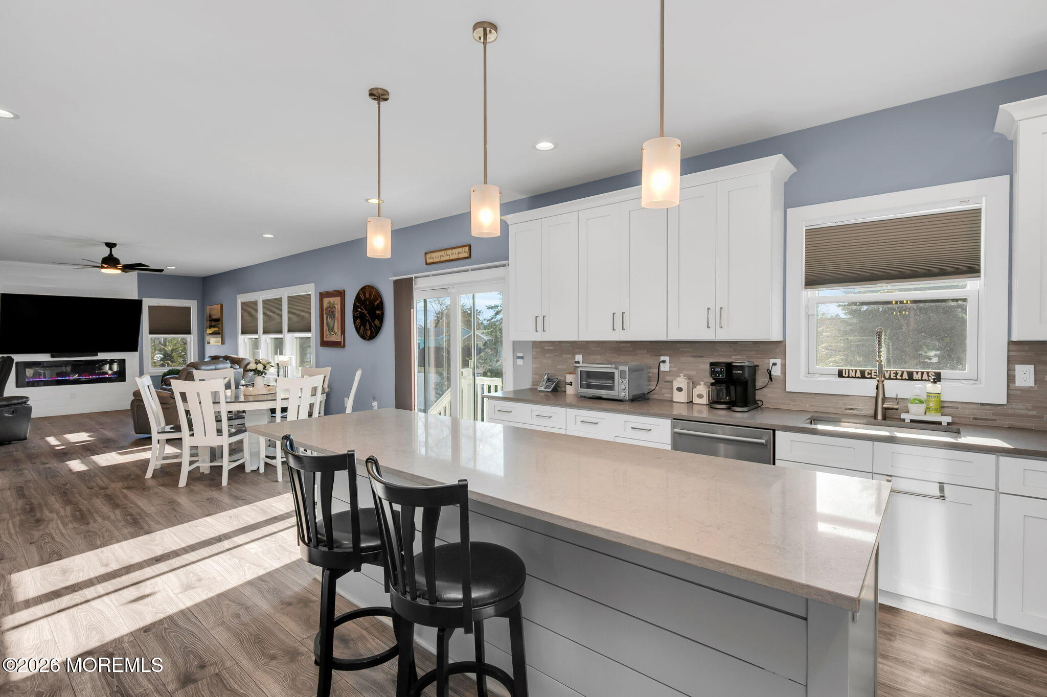 312 Elm Court Brick, NJ 08723 - Photo 27 of 57 a kitchen with stainless steel appliances kitchen island granite countertop a table chairs and a view of living room