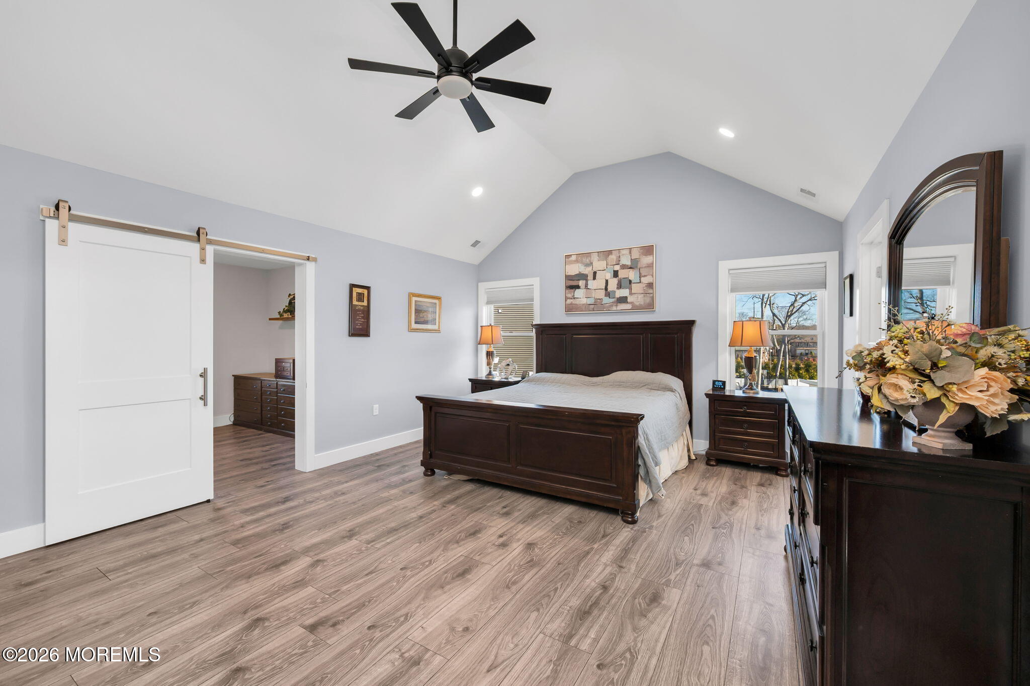 312 Elm Court Brick, NJ 08723 - Photo 29 of 57 a spacious bedroom with a bed and a chandelier