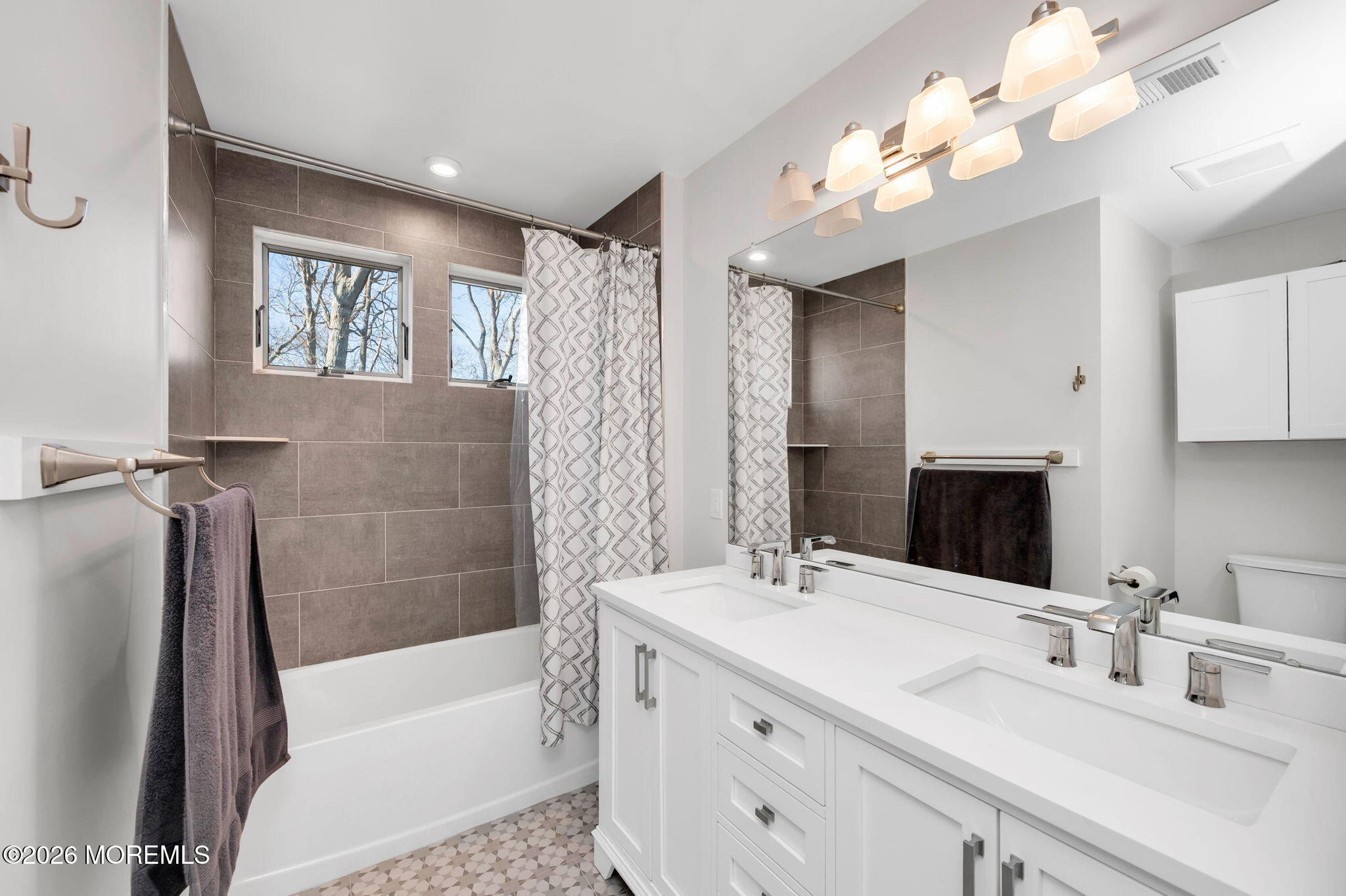 312 Elm Court Brick, NJ 08723 - Photo 46 of 57 a bathroom with a tub a sink and a mirror