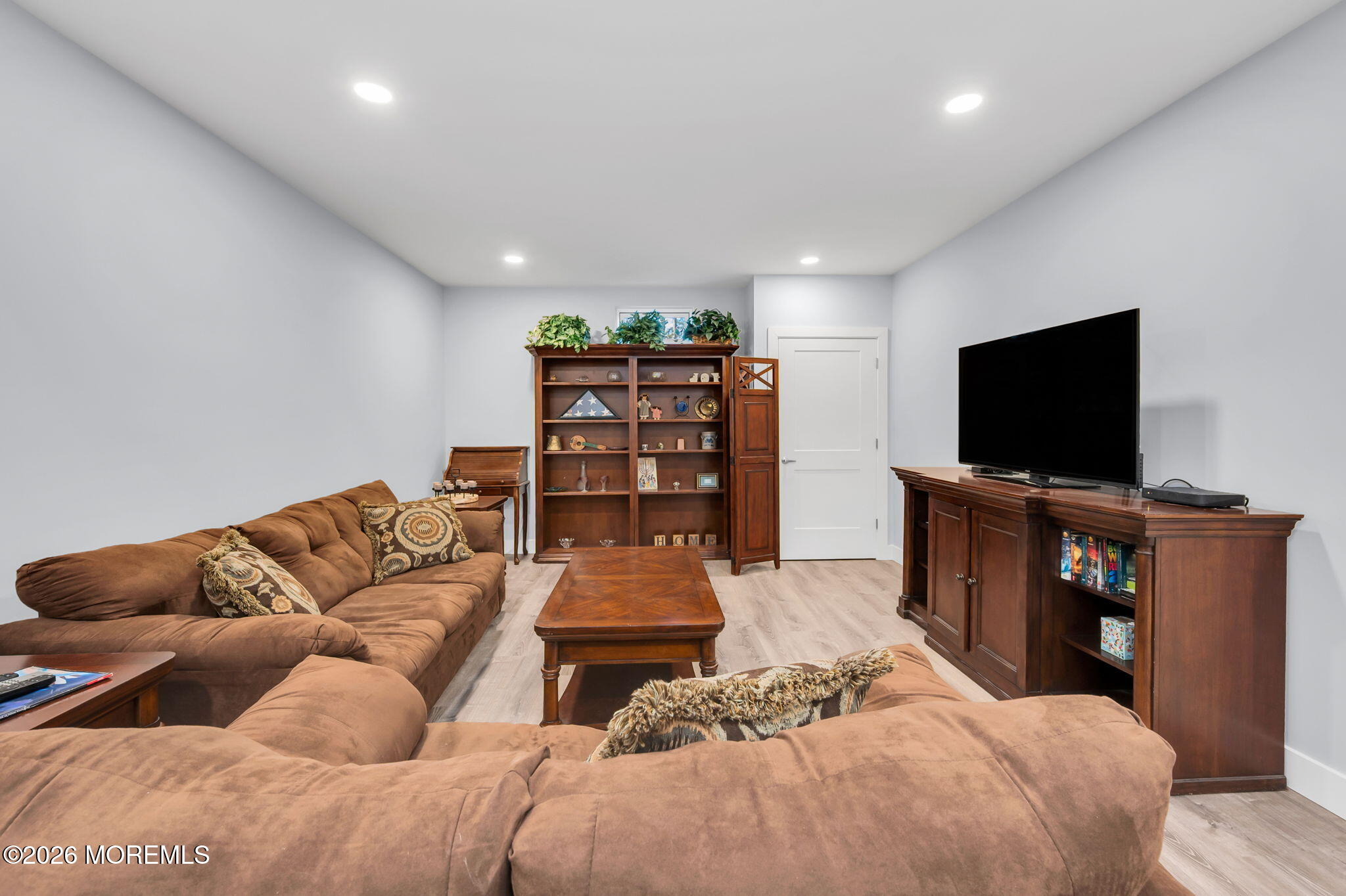 312 Elm Court Brick, NJ 08723 - Photo 50 of 57 a living room with furniture and a flat screen tv