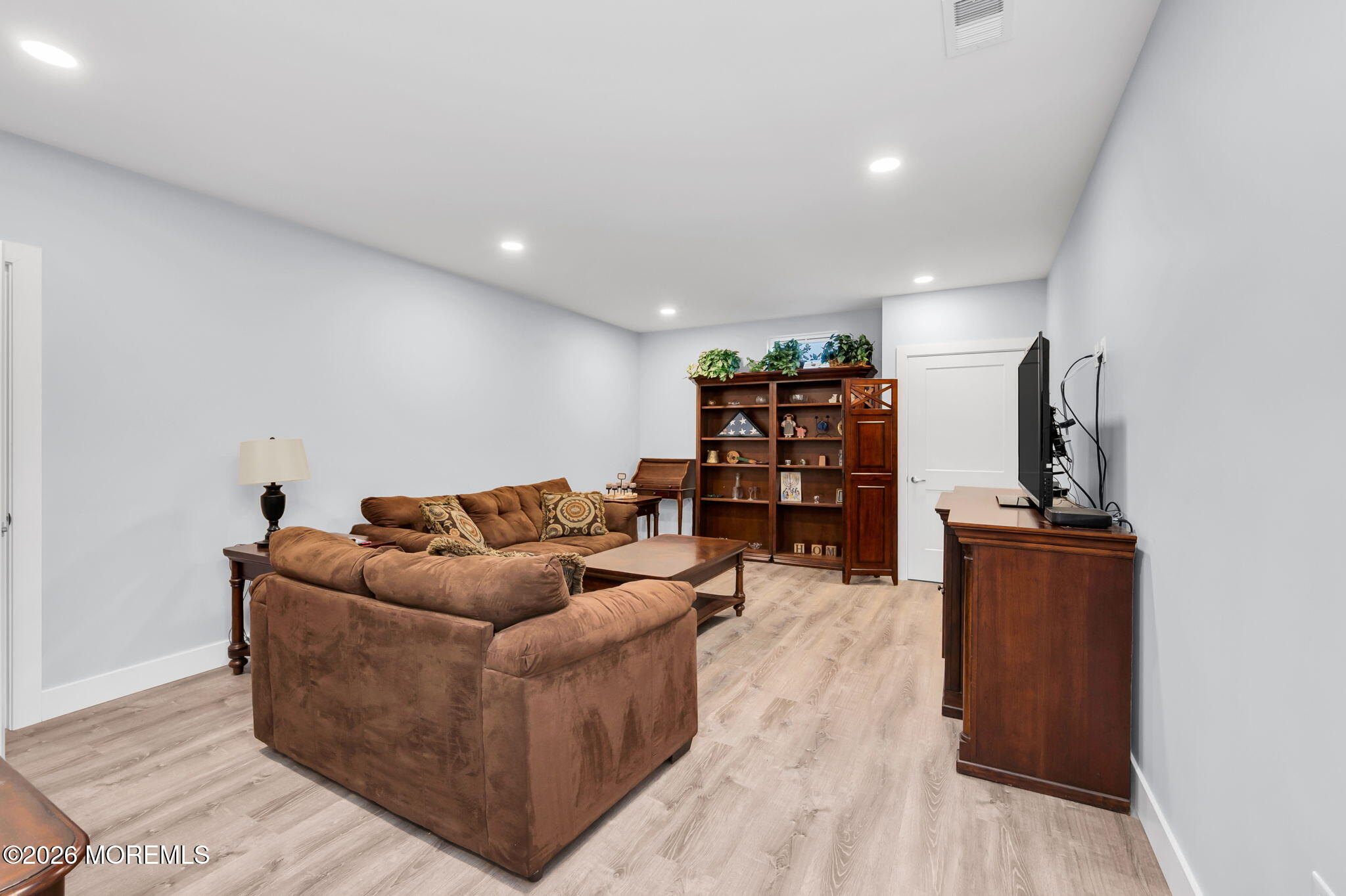312 Elm Court Brick, NJ 08723 - Photo 51 of 57 a living room with furniture and a flat screen tv