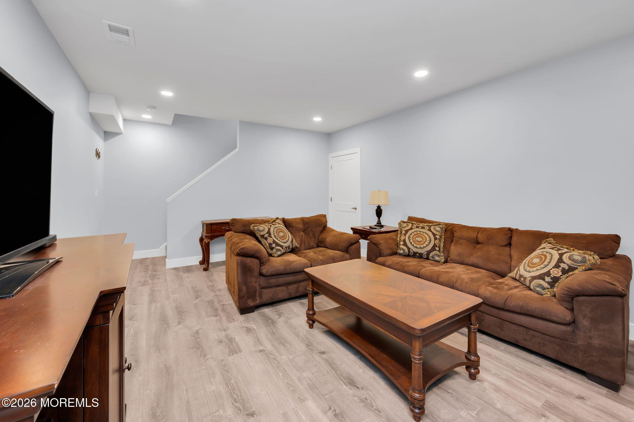 312 Elm Court Brick, NJ 08723 - Photo 53 of 57 a living room with furniture and a flat screen tv