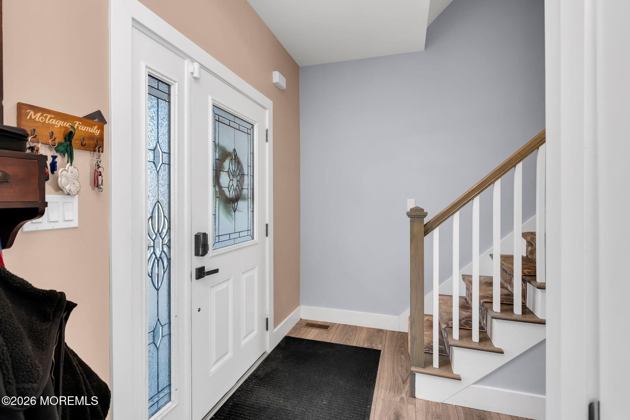 312 Elm Court Brick, NJ 08723 - Photo 9 of 57 a view of a hallway with wooden floor and staircase