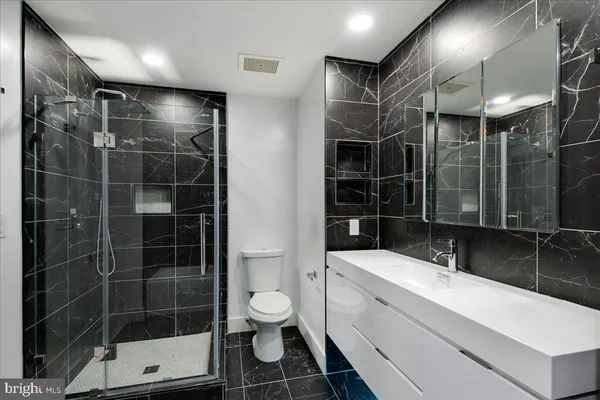 a bathroom with a sink toilet and shower