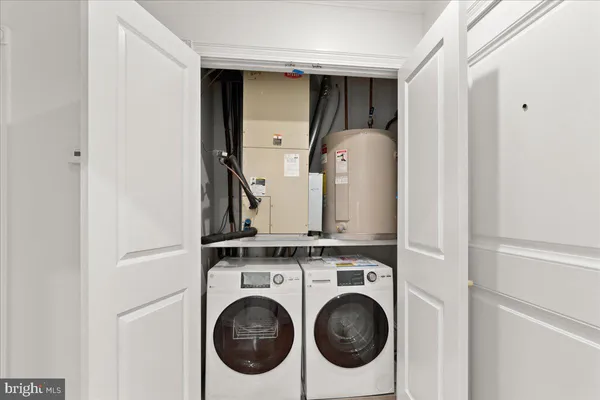 a view of storage and utility room with closet