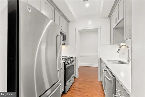 a kitchen with a sink stove and refrigerator
