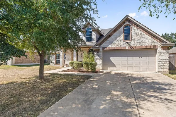 a front view of a house with a yard and garage