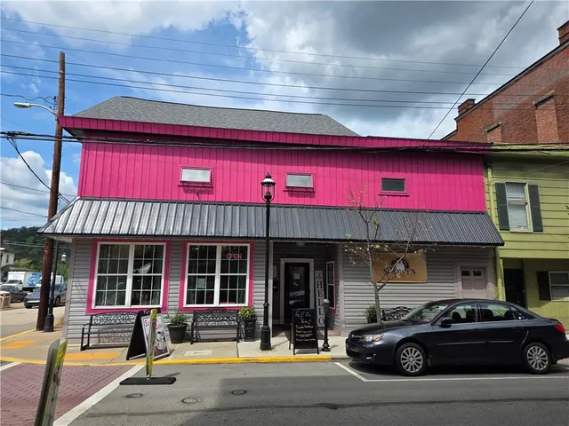 a view of a building with car parked