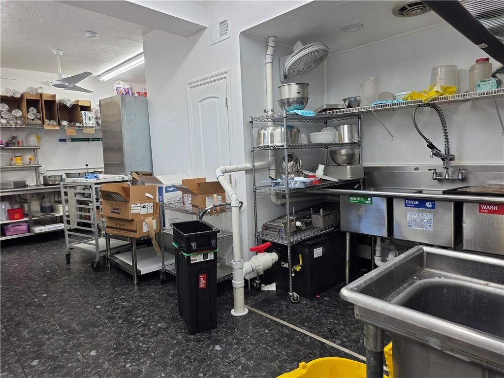 122 South 2nd Avenue Elizabeth, PA 15037 - Photo 18 of 23 a storage room with stainless steel appliances kitchen island granite countertop a sink and cabinets