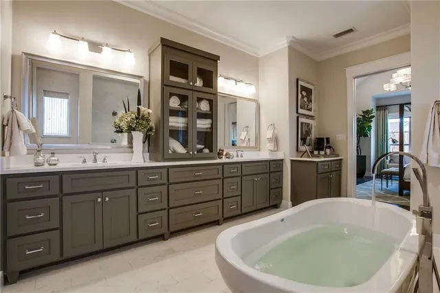 a spacious bathroom with a tub sink and mirror