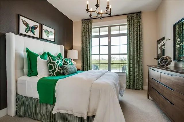 a bedroom with a bed mirror and a window