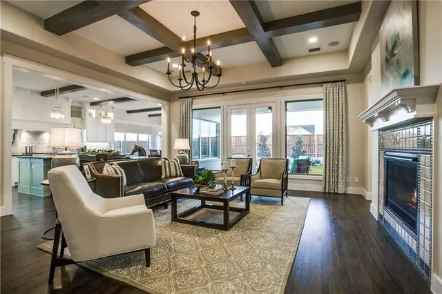 a living room with furniture a fireplace and a chandelier