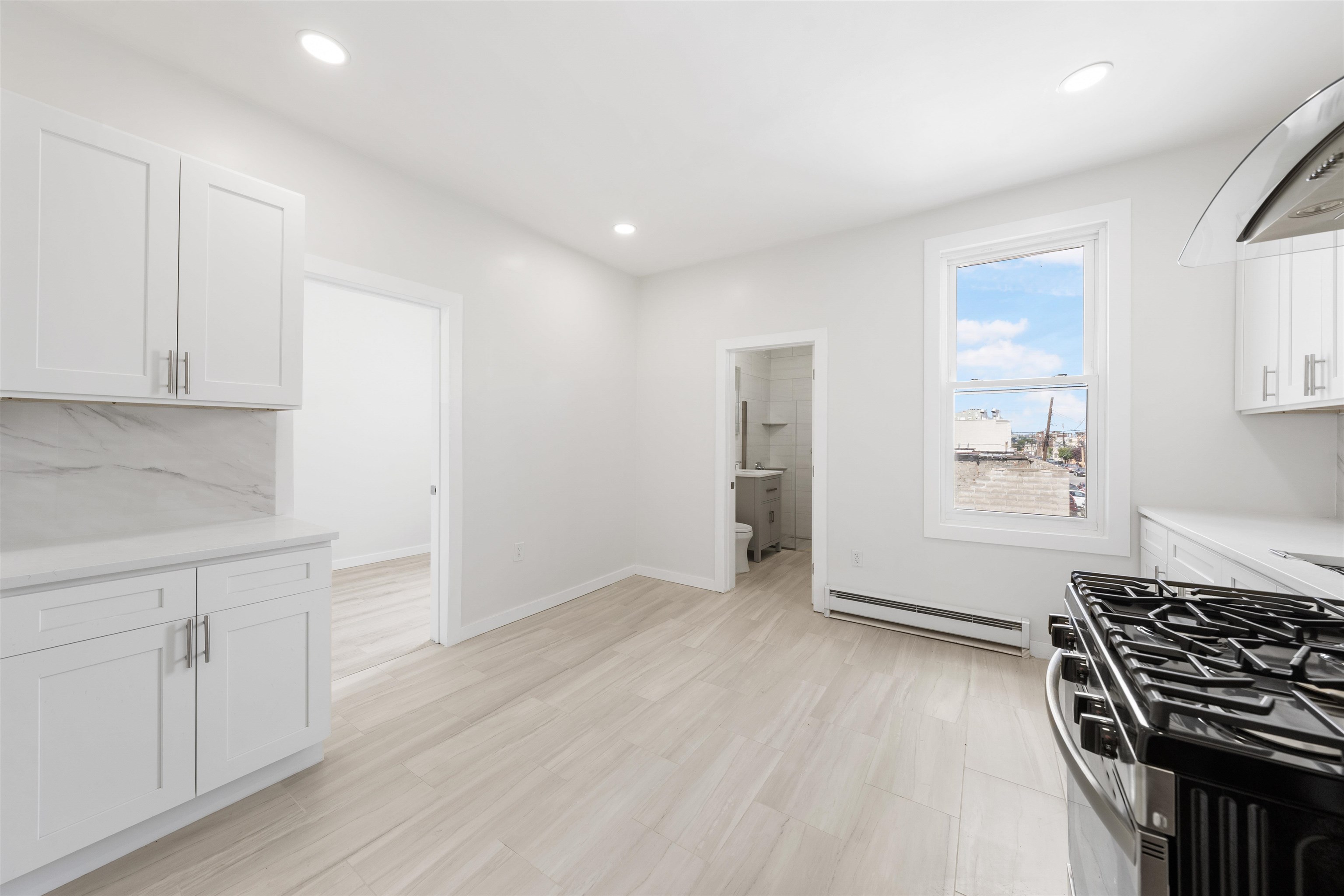 600 67th Street, Unit 2 West New York, NJ 07093 - Photo 11 of 13 a view of an empty room with wooden floor and a window