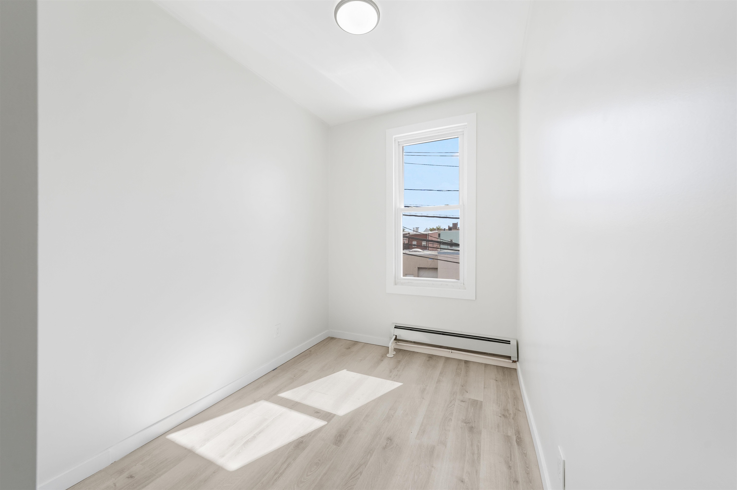 600 67th Street, Unit 2 West New York, NJ 07093 - Photo 13 of 13 a view of a room with wooden floor and windows