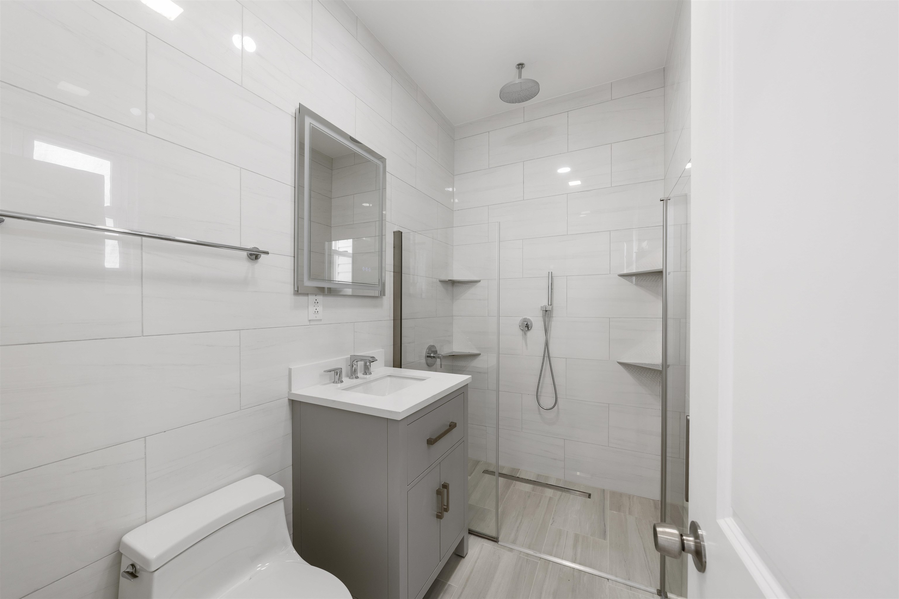 600 67th Street, Unit 2 West New York, NJ 07093 - Photo 5 of 13 a bathroom with a toilet sink and mirror