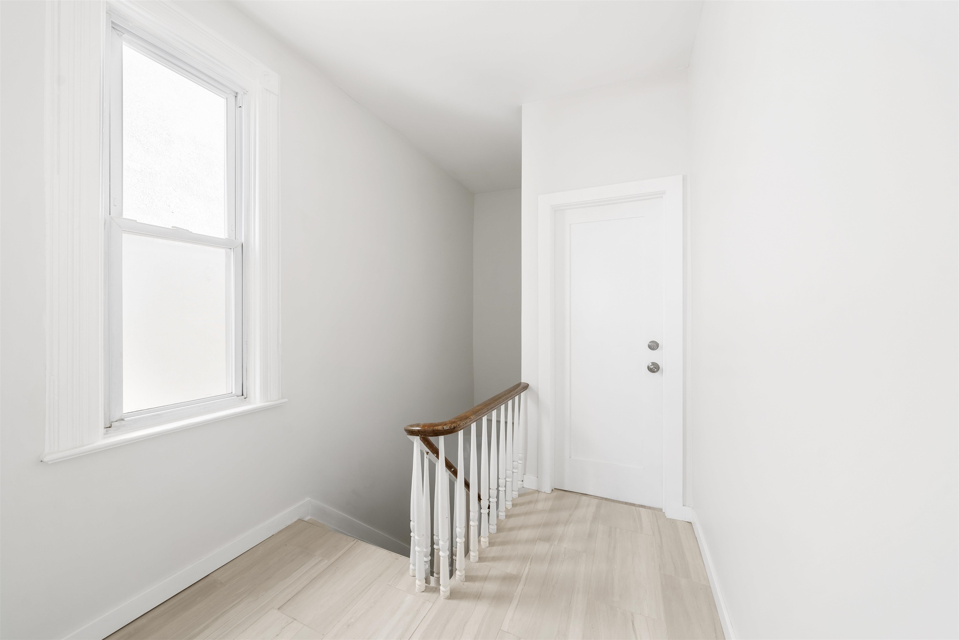600 67th Street, Unit 2 West New York, NJ 07093 - Photo 6 of 13 a view of a hallway with wooden floor and a window
