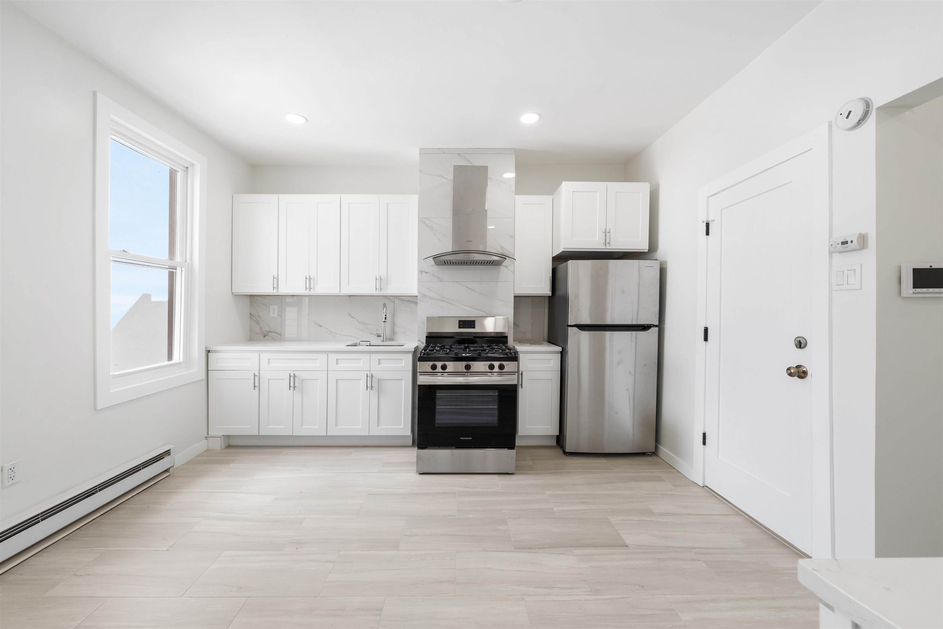 600 67th Street, Unit 2 West New York, NJ 07093 - Photo 8 of 13 a kitchen with stainless steel appliances a refrigerator sink and cabinets