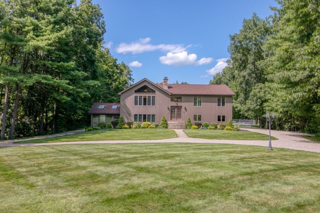 65 White Loaf Road Southampton, MA 01073 - Photo 1 of 33 a front view of a house with a yard and trees