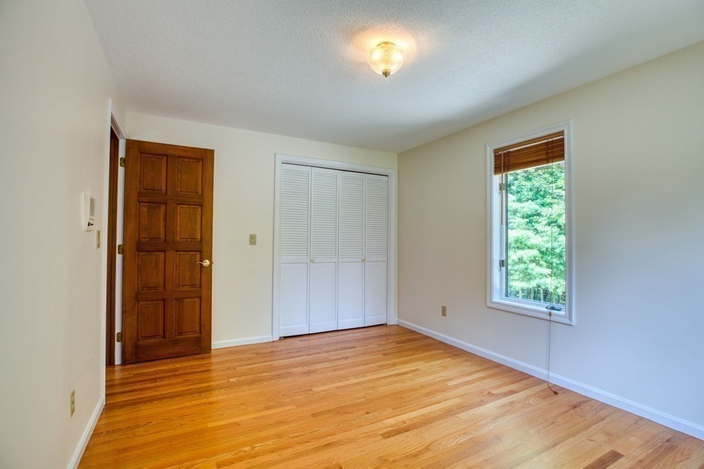 65 White Loaf Road Southampton, MA 01073 - Photo 21 of 33 a view of an empty room with window and wooden floor