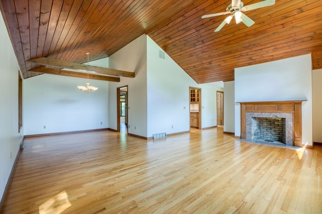 65 White Loaf Road Southampton, MA 01073 - Photo 4 of 33 a view of empty room with wooden floor and fireplace