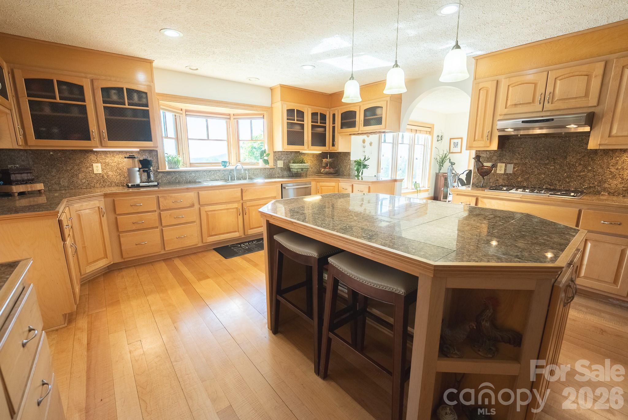6985 Junaluska Road Boone, NC 28607 - Photo 20 of 35 a kitchen with stainless steel appliances granite countertop a sink a stove and cabinets