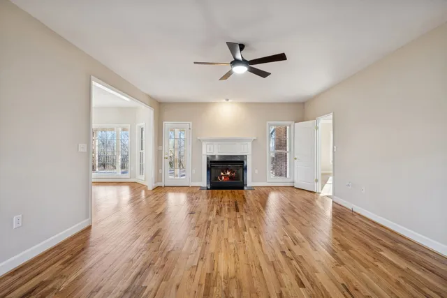 a view of a kitchen with wooden floor and a sink