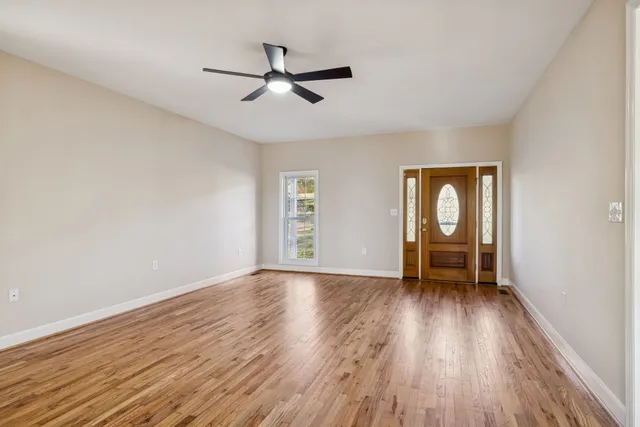 a kitchen with granite countertop a stove and a wooden floors