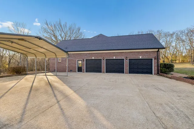 a kitchen with granite countertop wooden cabinets stainless steel appliances and a window