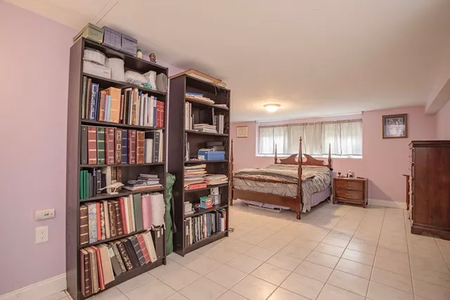 a bedroom with furniture and a book shelf