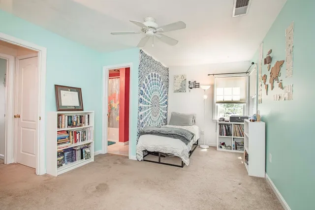 a spacious bedroom with a bed and a book shelf