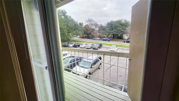 a view of a balcony with chair and tables