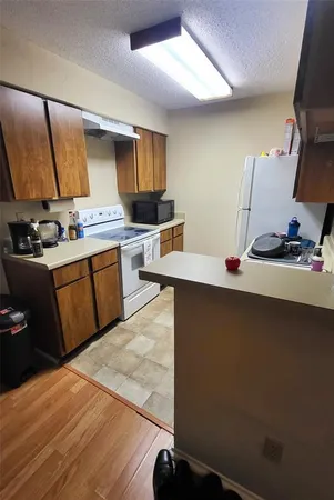 a kitchen with a sink appliances and cabinets