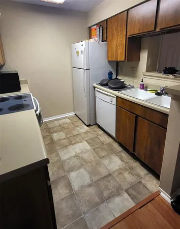 a kitchen with a sink cabinets and appliances