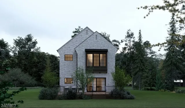 a front view of a house with a yard and trees