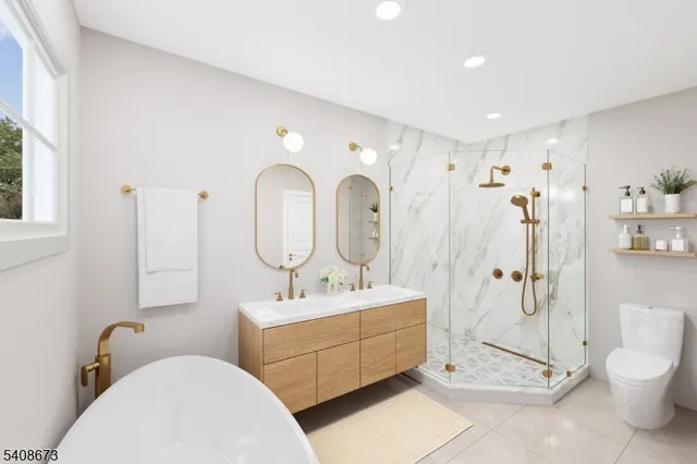 a bathroom with a toilet sink mirror and shower
