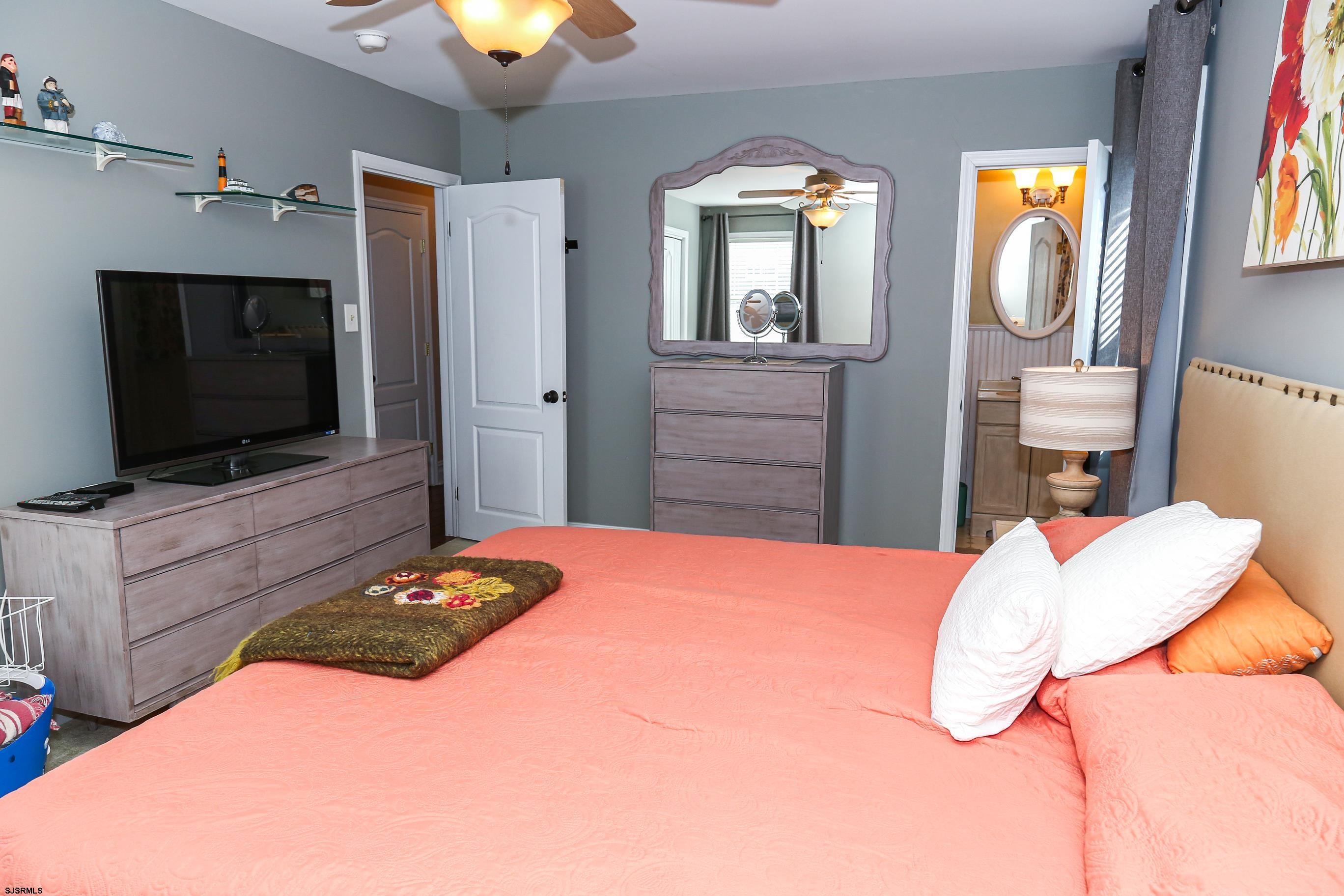 5216 Waterview Drive Brigantine, NJ 08203 - Photo 12 of 57 a bedroom with a bed and a flat screen tv