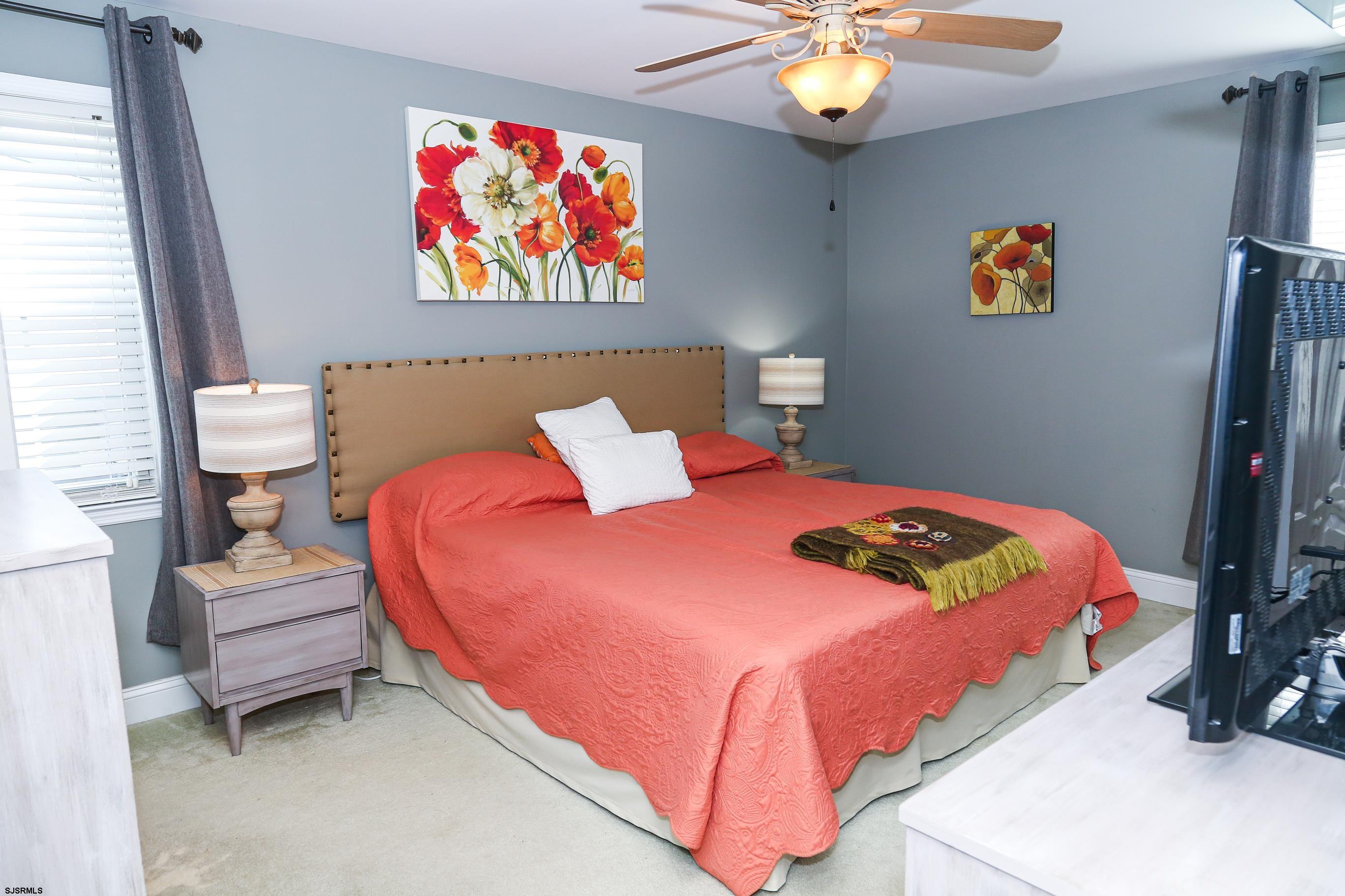 5216 Waterview Drive Brigantine, NJ 08203 - Photo 13 of 57 a bedroom with a bed and a chandelier